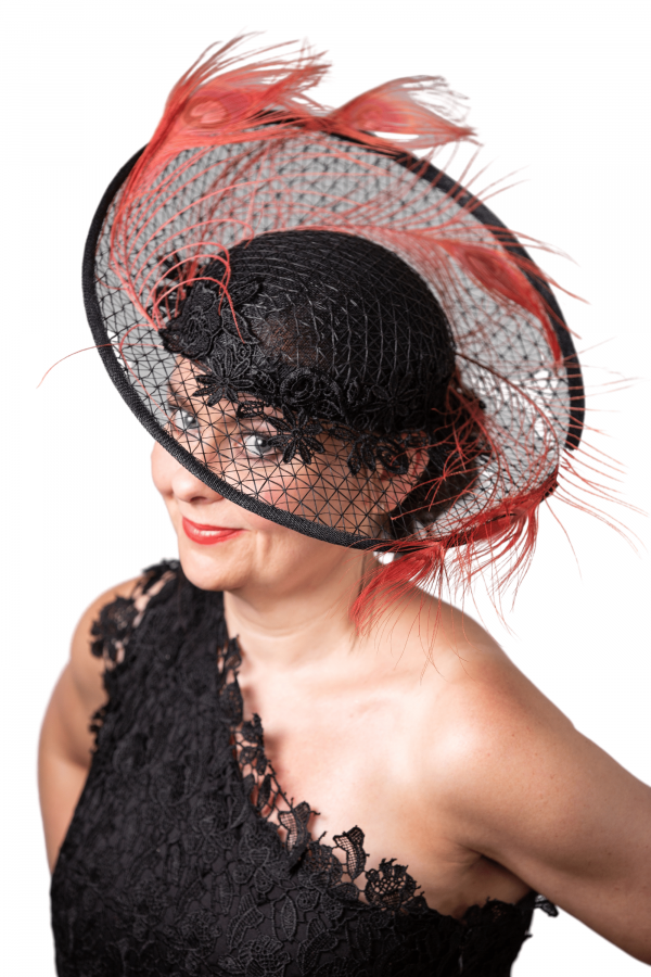 Full on side image od hat with model looking directly through transparent brim to camera.