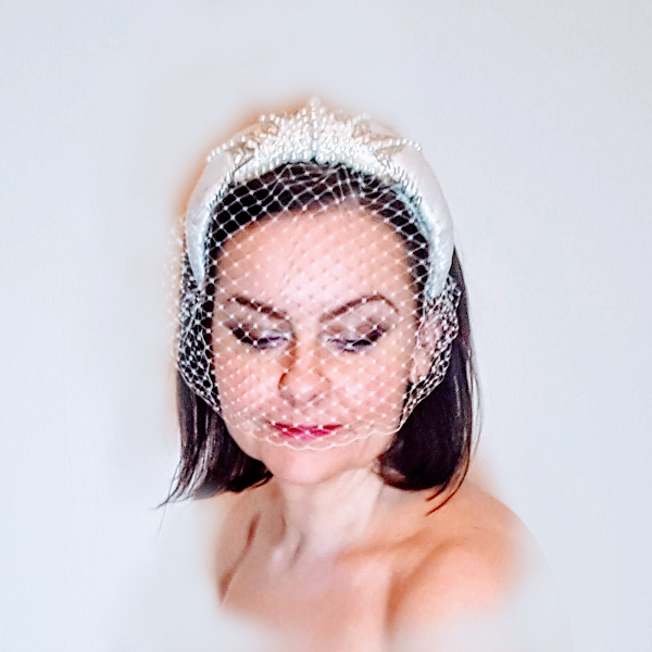 Bridal couture satin veiled headband Bridal couture satin veiled headband model looking forward and eyes down