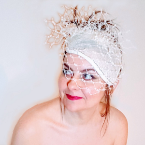 Ivory pearl veiled bridal millinery looking up to left small