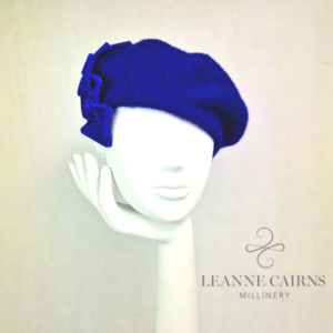 Royal Blue Wool French Beret and velvet ribbon detailed style hat on mannequin , front view